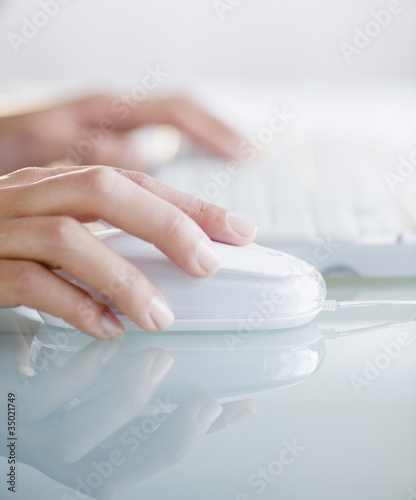 Photo: Hands operating computer mouse and keyboard Hands operating computer mouse and keyboard