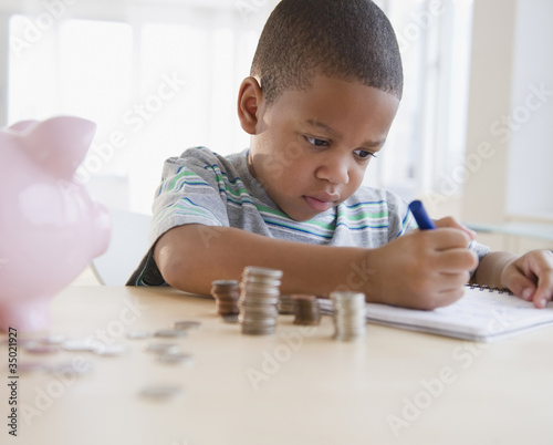 Photo: African American boy counting coins African American boy counting coins