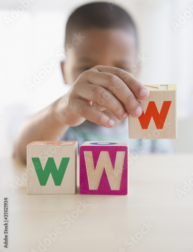 Photo: African American boy spelling WWW with blocks African American boy spelling WWW with blocks