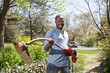 Black man holding weed trimmer