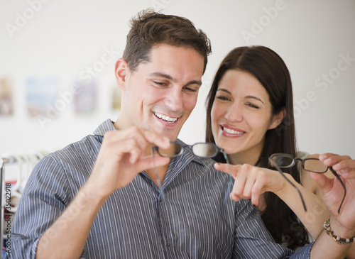 Photo: Smiling couple shopping for eyeglasses together Smiling couple shopping for eyeglasses together