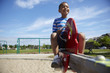Black boy playing on seesaw at playground