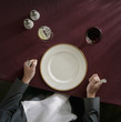 Caucasian woman waiting in front of empty plate
