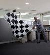 African American businessman waving checkered flag in office