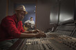 African American man working at audio control panel