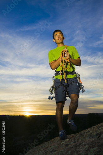Photo: Hispanic man preparing for rock climbing Hispanic man preparing for rock climbing