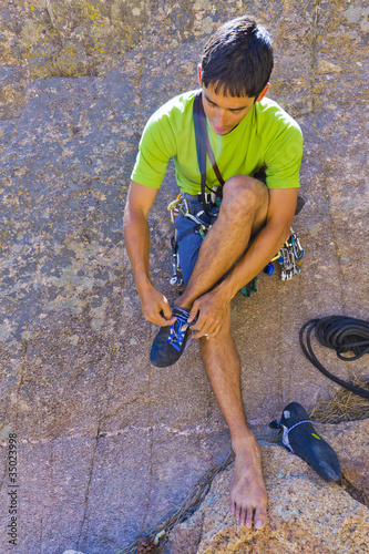 Photo: Hispanic man preparing for rock climbing Hispanic man preparing for rock climbing