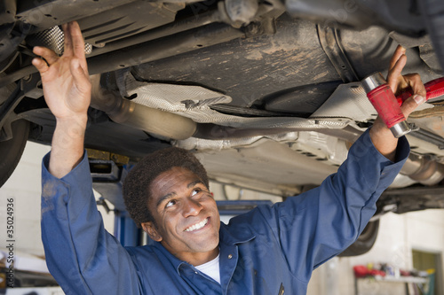 Photo: Mixed race mechanic working in auto repair shop Mixed race mechanic working in auto repair shop