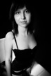 Young woman in lingerie against dark balck background
