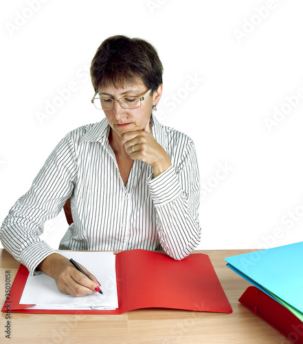 Photo: Older woman working at desk, administration Older woman working at desk, administration
