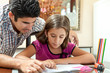 Latin father helping his daughter with homework