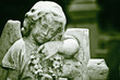 Old statue of an infant angel  in green shades