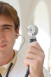 Smiling young worker standing with a stethoscope
