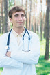Smiling young doctor at the park