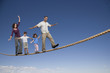 Family walking across tightrope