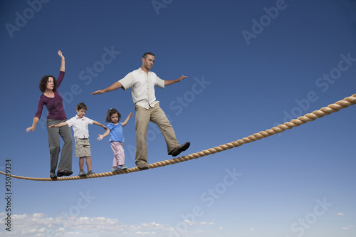 Photo: Family walking across tightrope Family walking across tightrope