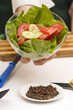 woman presents salad