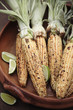 Roasted corn on the cob and limes in bowl