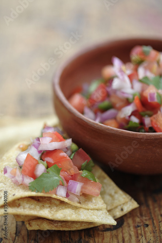 Photo: Salsa fresca in bowl and on tortilla chip Salsa fresca in bowl and on tortilla chip