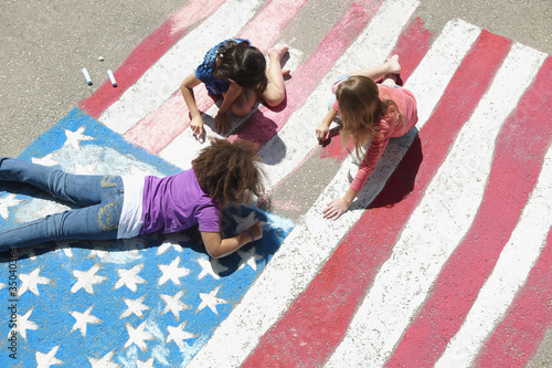 Photo: Girls with chalk coloring American flag on sidewalk Girls with chalk coloring American flag on sidewalk