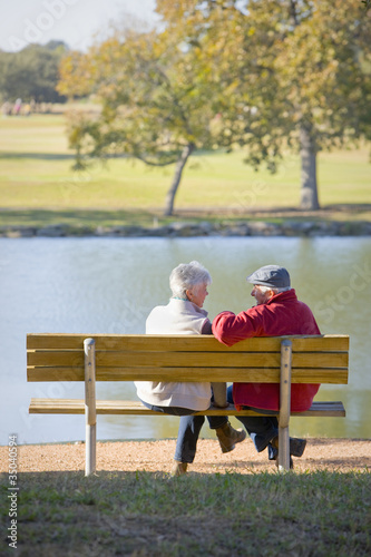 Photo: Senior couple sitting on park bench Senior couple sitting on park bench