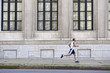 African American man running on city sidewalk