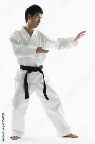 Photo: Asian male black belt practicing karate Asian male black belt practicing karate