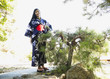 Mixed race woman in garden wearing Japanese kimono