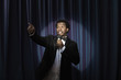 Black man in tuxedo holding microphone