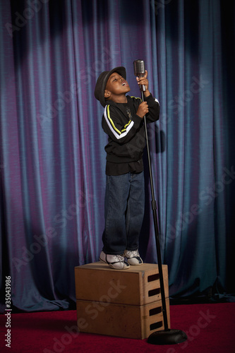 Photo: Black boy on crate singing into microphone Black boy on crate singing into microphone
