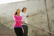 Grandmother and granddaughter running down urban steps