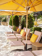 Photo: "Chaise lounge chairs under umbrellas at luxury resort in Napa Valley, California" "Chaise lounge chairs under umbrellas at luxury resort in Napa Valley, California"
