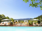 Photo: "Swimming pool with striped chaise lounge chairs and umbrellas at a luxury resort overlooking Napa Valley, California" "Swimming pool with striped chaise lounge chairs and umbrellas at a luxury resort overlooking Napa Valley, California"