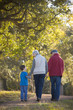 Grandparents walking with grandson in park