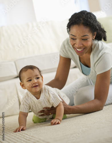 Photo: Mixed race mother playing with baby Mixed race mother playing with baby