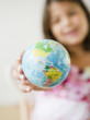 Hispanic girl holding small globe