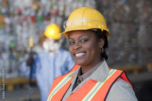 Photo: Black sanitation worker working in recycling plant Black sanitation worker working in recycling plant
