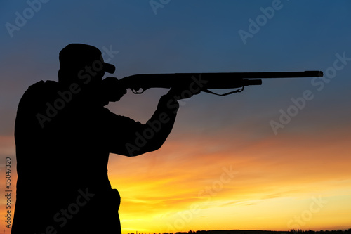 Photo: hunter with rifle gun hunter with rifle gun