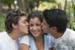 Hispanic men kissing woman