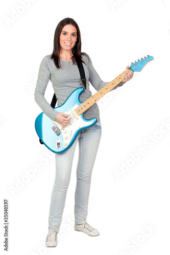Photo: Attractive girl with a blue electric guitar Attractive girl with a blue electric guitar
