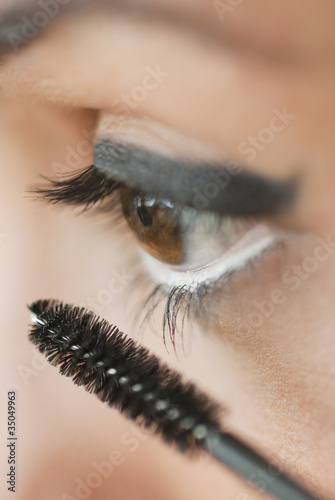 Photo: Caucasian woman putting on mascara Caucasian woman putting on mascara