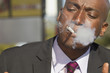 African American businessman smoking cigarette