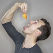Caucasian man eating a goldfish
