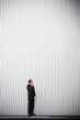 Uncertain groom standing near wall