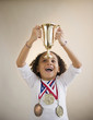 African American girl holding up trophy