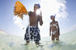 Couple discovering shell in ocean