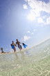 Couple wading in ocean carrying snorkeling gear
