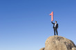 Caucasian businessman on rock lifting large number 1