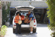 Black couple loading car for vacation