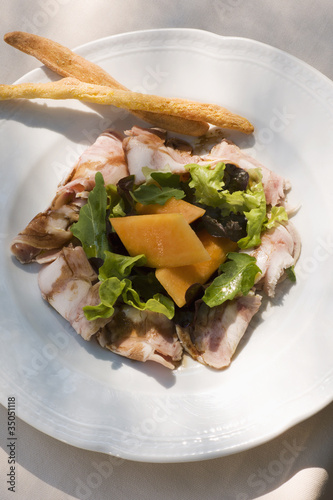 Photo: "Tuscany head cheese with salad, melon and breadsticks " "Tuscany head cheese with salad, melon and breadsticks "